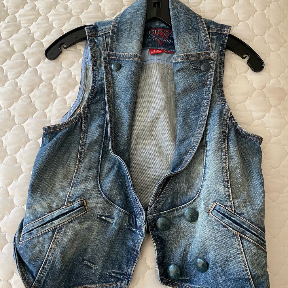This is a blue Guess premium vest. It is a size M with nice metal buttons.